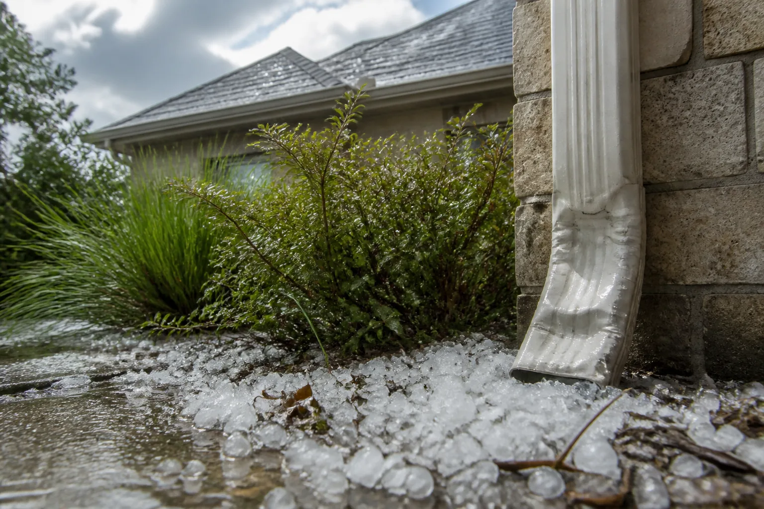 Hailstones and visible gutter conditions documented safely after a storm