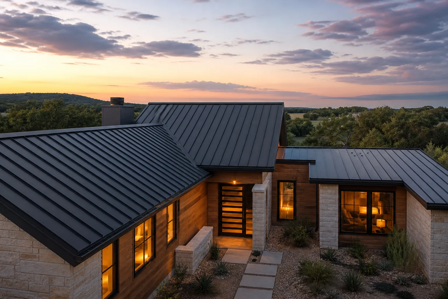Completed standing-seam metal roof on a contemporary Hill Country home at twilight